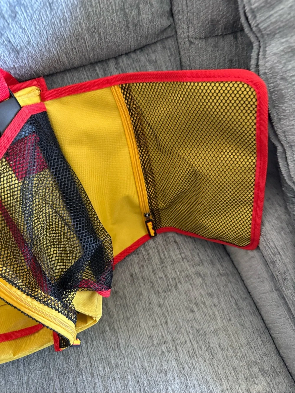 Kids travel activity organizer features a fold-out flat play surface. See detail